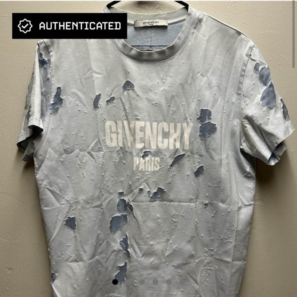 A Givenchy blue distressed shirt.